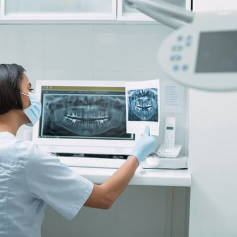 Dentist looking at all digital x-ray scans