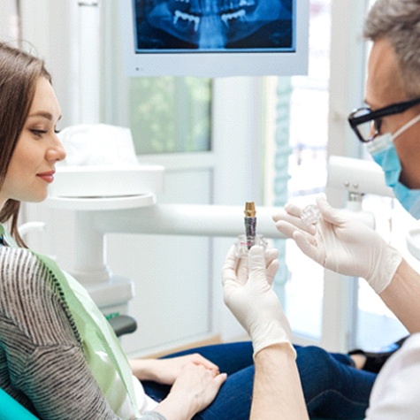 Implant dentist in McKinney explaining dental implant treatment