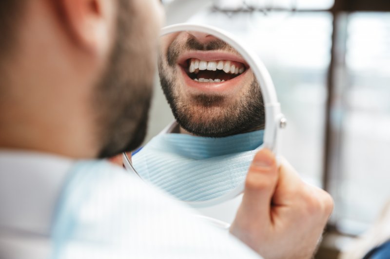 Patient smiling at work with dental implants